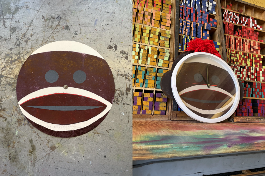 Sock clock sitting against a wall in a type shop.